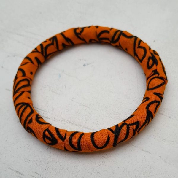 Orange and Black African fabric and brass bangles by Jumandy Fabrics at Amanartis at the Atria by Amma Gyan 3